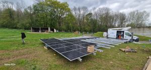 Panneau solaire bâtiment agricole : des professionnels Ensio préparent une structure composée de plusieurs panneaux photovoltaïques avant son installation.